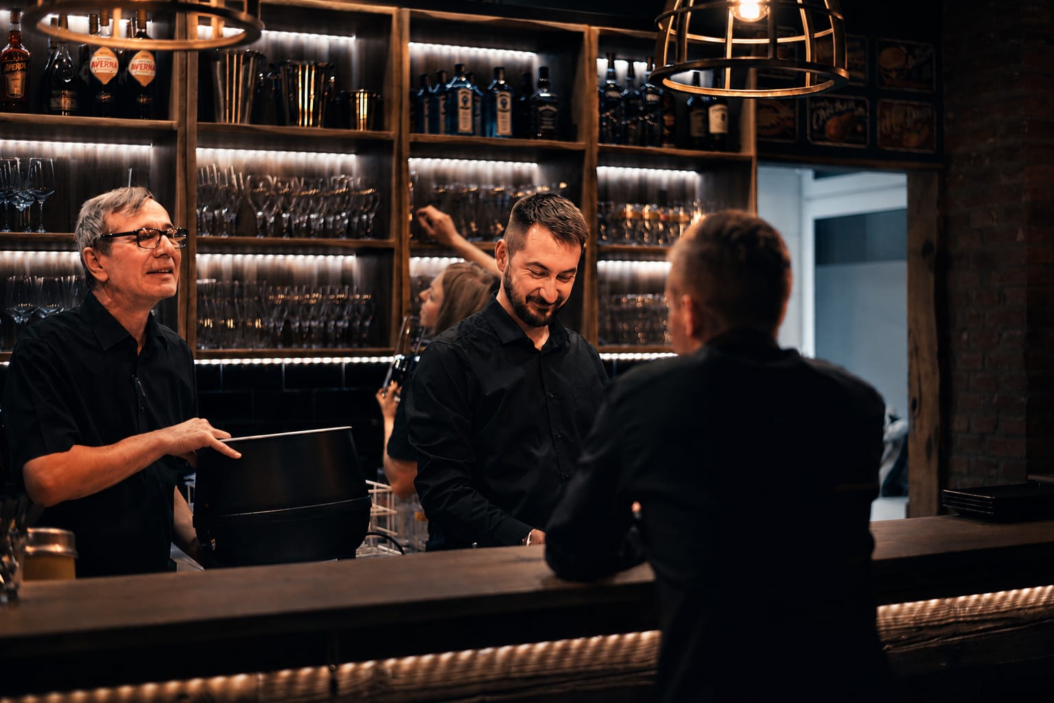 Bandita hospitality content — bartenders at a moody, premium bar